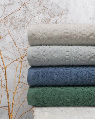 Organic waffle linen towels, bamboo toothbrushes, bathroom zero waste accessories in grey shades in contemporary bathroom interior. Daily body care, spa and wellness zero waste bathroom concept